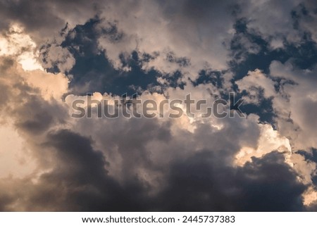 bright sun in back sky day scene dark clouds over cereal fields with rays of light