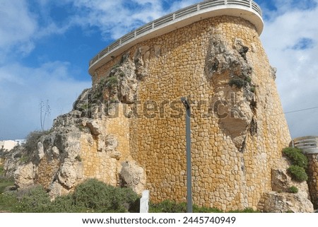 Stone watchtower on a cliff with clear sky. Historical architecture photography. Travel and exploration concept. Design for education, travel brochure, poster