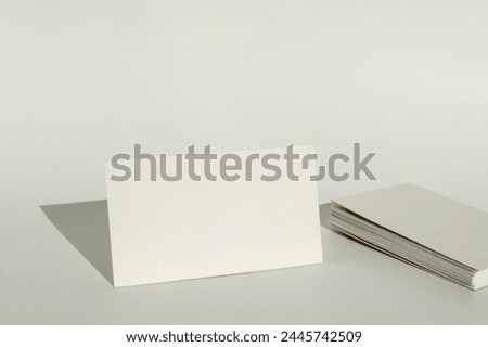 White blank business card on brown paper background with soft shadow. Corporate identity and stationery mockup concept with copy space