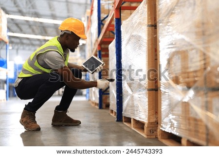 African american worker in warehouse, International import export and logistic business concept. Logistics, transportation, distribution concept. Factory worker working in logistic warehouse.