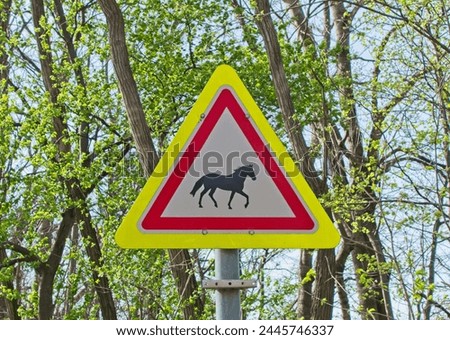 Road sign with the image of a horse. Sign caution Horse and rider crossing. Road sing of Hungary, Europe. 