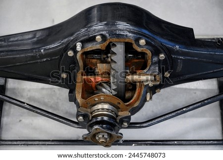 A close-up view of the interior of the rear axle of a mid-20th century truck with wires and gears Royalty-Free Stock Photo #2445748073
