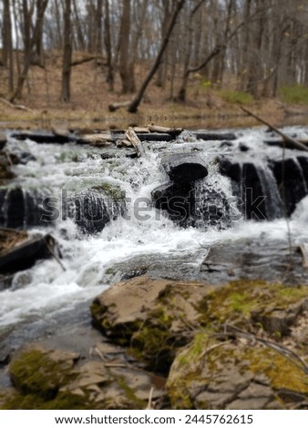 roaring waterfall on a river in the woods