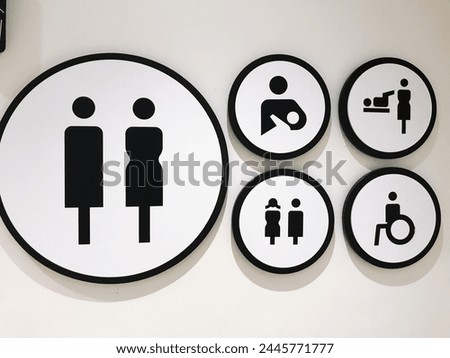 Male and female toilet signs on the wall of a shopping center.