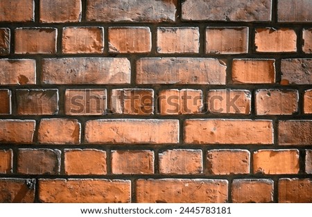 Old and aged red brick wall texture background with vignetting.