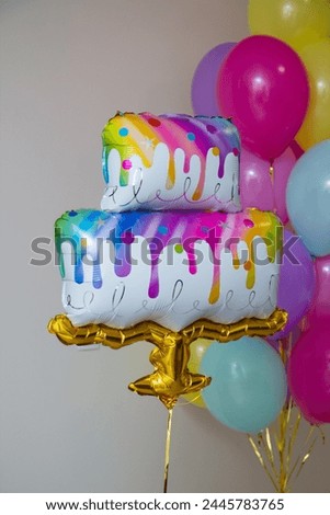 birthday cake with candles and balloons