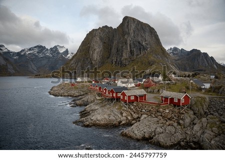 Famous photography spot of Hamnoy red rorbu fishing houses from the nearby bridge.  Located in Lofoten, Norway in the Arctic circle.  A famous fishing village. Royalty-Free Stock Photo #2445797759
