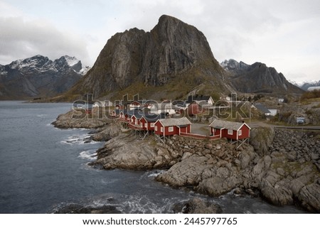Famous photography spot of Hamnoy red rorbu fishing houses from the nearby bridge.  Located in Lofoten, Norway in the Arctic circle.  A famous fishing village. Royalty-Free Stock Photo #2445797765