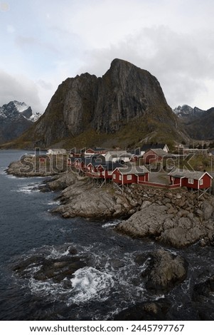 Famous photography spot of Hamnoy red rorbu fishing houses from the nearby bridge.  Located in Lofoten, Norway in the Arctic circle.  A famous fishing village. Royalty-Free Stock Photo #2445797767