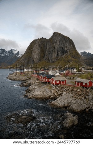 Famous photography spot of Hamnoy red rorbu fishing houses from the nearby bridge.  Located in Lofoten, Norway in the Arctic circle.  A famous fishing village. Royalty-Free Stock Photo #2445797769