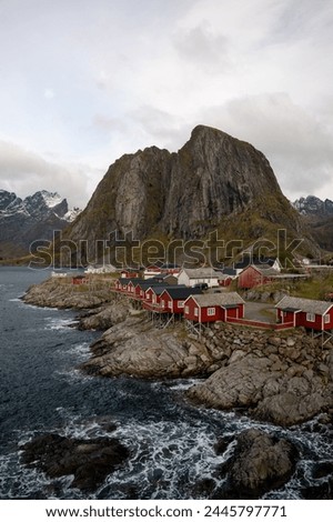 Famous photography spot of Hamnoy red rorbu fishing houses from the nearby bridge.  Located in Lofoten, Norway in the Arctic circle.  A famous fishing village. Royalty-Free Stock Photo #2445797771