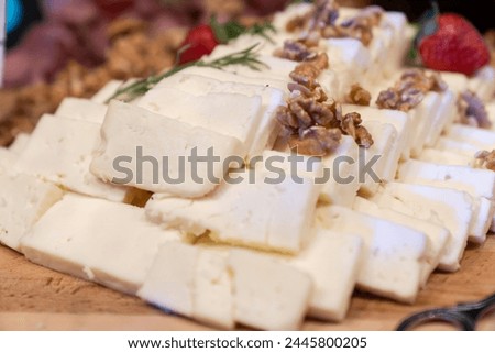 Board with different types of cheese: Dor blu, chedar, Parmesan, brie, honey sauce, finger bread and strawberry. Restaurant menu plate. cheese platter.
Roquefort cheese, mozzarella and parmesan.
 Royalty-Free Stock Photo #2445800205