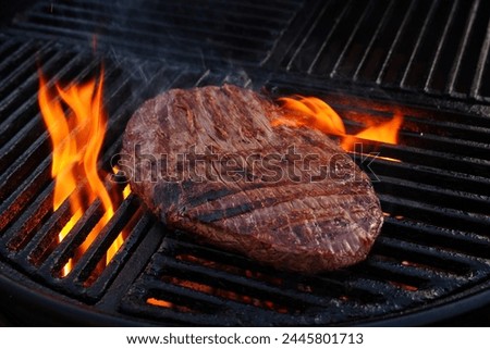 Traditional American barbecue flanksteak steak as close-up on a charcoal grill with fire  Royalty-Free Stock Photo #2445801713
