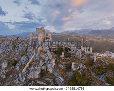 Aerial view taken by drone of Rocca Calascio castle during an autumn sunrise, National Park of Gran Sasso and Monti of Laga, Abruzzo, Italy, Europe Royalty-Free Stock Photo #2445814799