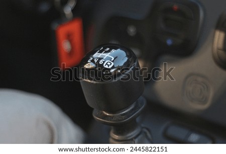 Step into the driver's seat and witness the intricate dance of hand and gear lever as the driver executes a manual gear change with precision and finesse Royalty-Free Stock Photo #2445822151