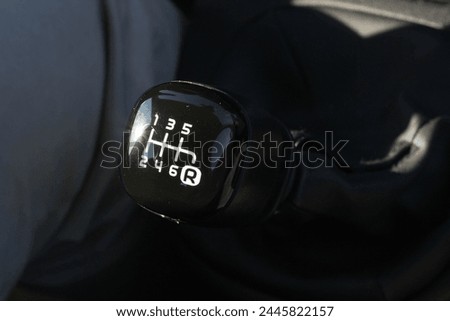 Step into the driver's seat and witness the intricate dance of hand and gear lever as the driver executes a manual gear change with precision and finesse Royalty-Free Stock Photo #2445822157