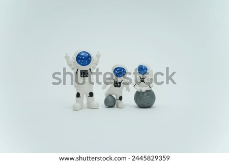 Three Plastic toy figure astronaut on a white background. Copy space. Close up. The concept of spaceman and space, commercial flights      