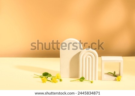 Stylish composition with yellow flowers and plaster figures. Bright spring background, product presentation. Copy space.