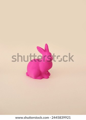 Pink 3d printed Easter bunny on beige background