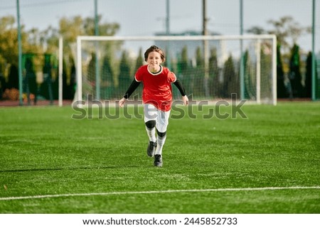 A young boy with boundless energy races across the green soccer field, his determination evident in every stride he takes towards the goalpost. Royalty-Free Stock Photo #2445852733