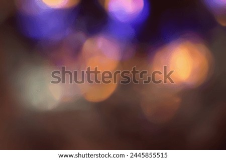 Defocused neon glow. Overlaying highlights. Futuristic LED lighting. Color bokeh blur on dark abstract background