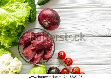 Cooking raw meat with spices and vegetables. Diet food background.