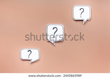 Ask and answer concept. Question marks on speech bubbles, top view.