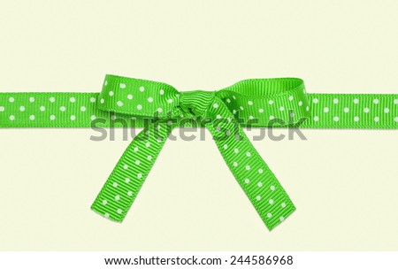 gift in packing with a green bow white in peas