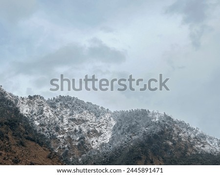 Snowfall on hills is a natural occurrence that happens when atmospheric conditions are cold enough for moisture to freeze and fall as snow instead of rain. The higher altitude of hills and mountains. Royalty-Free Stock Photo #2445891471
