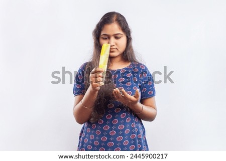 indian women suffering from hair fall brushing hair using a comb
