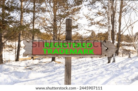 Registered trademark symbol. Concept word Registered trademark beautiful wooden road sign. Beautiful forest snow blue sky background. Business and registered trademark concept. Copy space.