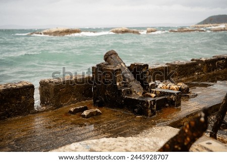 Rusty Winch on Stormy Seaside Dock Royalty-Free Stock Photo #2445928707