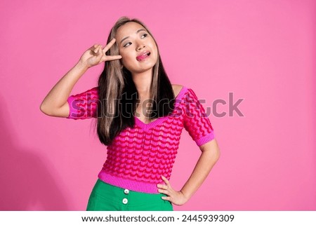 Photo of funky tricky lady dressed knitted shirt stick out showing v-sign cover eye looking emtpy space isolated pink color background