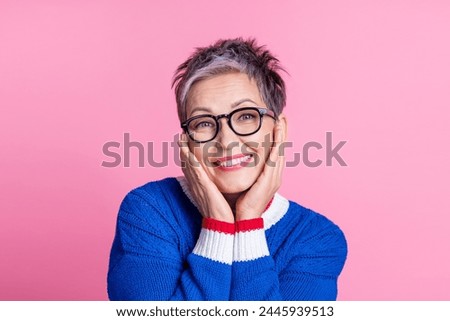 Photo of nice aged lady hands touch cheeks wear blue sweater isolated on pink color background