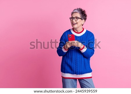 Photo of cheerful woman pensioner wear blue trendy clothes buy credit offer modern device empty space isolated on pink color background