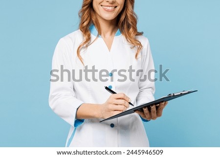 Cropped close up female doctor woman she wears white gown suit work in hospital clinic office holding clipboard sign medical documents isolated on plain blue background. Health care medicine concept