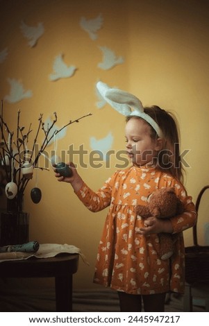 little child playing with easter bunny, little girl with bunny ears, basket with easter eggs, Easter, Easter eggs, child with plowing basket, holiday