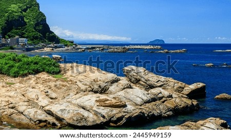 Peculiar rocks in forms of a seal and a Flip Flop at Nanya of Rueifang District in New Taipei City, Northeastern Taiwan, a unique geological landscape formed by coastal erosion of sedimentary rocks. Royalty-Free Stock Photo #2445949159