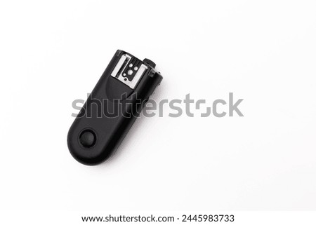 Isolated image of a sleek black universal remote control with empty space for text