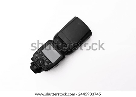 Top view of a modern camera flash isolated on a white background