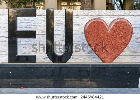 Text EU and heart, concept of love for the European Union. Background with selective focus and copy space for text