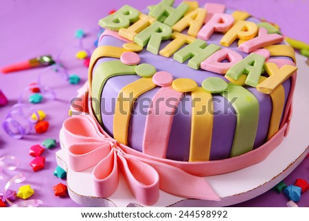 Delicious birthday cake on table close-up