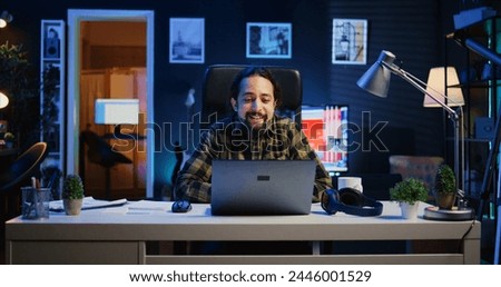 Man checking up on abroad living friend during video conference meeting over the internet. Caucasian person enjoying time together with mate in online video call session while at home, camera B Royalty-Free Stock Photo #2446001529