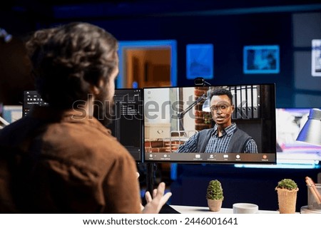 IT specialist working from home in videocall with coworker, testing and deploying programs and systems. Programmer checking code with colleague in teleconference, sitting at desk chair in apartment Royalty-Free Stock Photo #2446001641