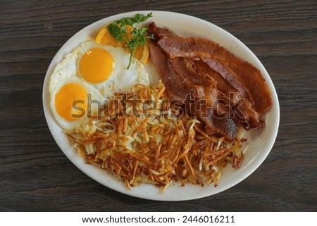 bacon and eggs breakfast on a wooden background Royalty-Free Stock Photo #2446016211
