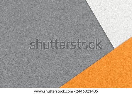 Texture of craft gray color paper background with white and orange border. Vintage abstract grey cardboard. Presentation template and mockup with copy space. Felt backdrop closeup.