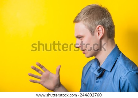 portrait of excited businessman over yellow background