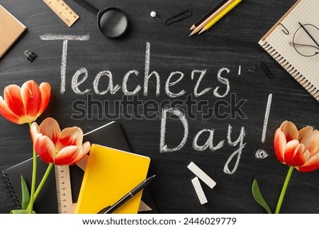 Show gratitude to your educator on Teacher's Day with this setup. Top view shot of teacher's items, tulips, and blackboard with chalked greeting "Happy Teachers' Day!"