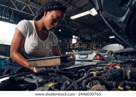 Portrait of woman Auto mechanic are repair mechanical part and maintenance auto engine is problems at car repair shop.