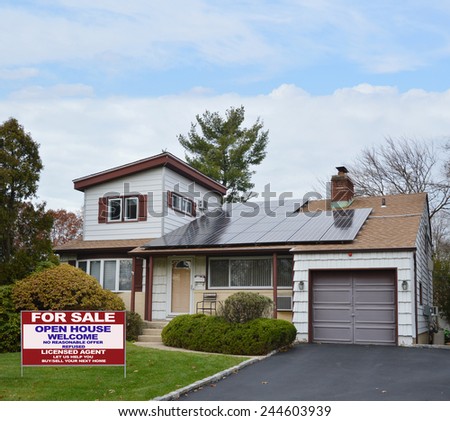 Real Estate for sale open house welcome sign Suburban Ranch style home with solar panel on roof residential neighborhood USA blue sky clouds